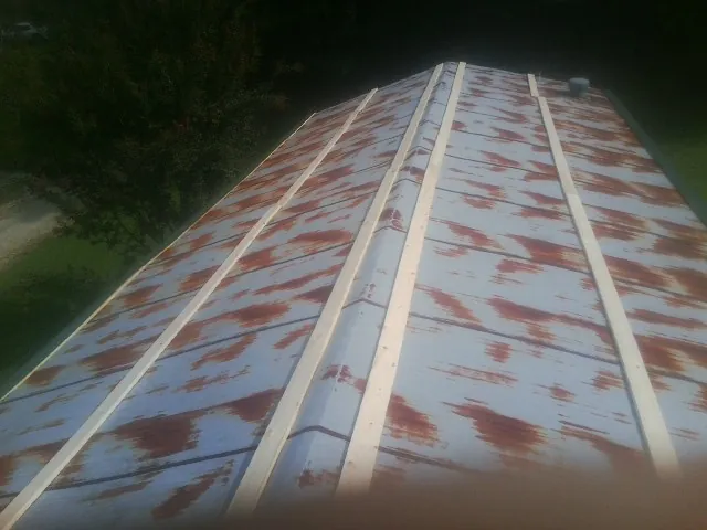 Rusted metal roof panels with new wood purlins before replacement — Storm Damage Roof Repair in Waco by Roofing Brothers